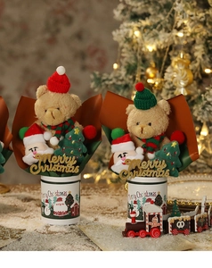 Close-up of Christmas plush bouquet with bear and Santa in a white gift cylinder