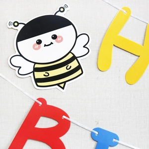 Detail of bee cutout and colorful HB letters on string for birthday party banner