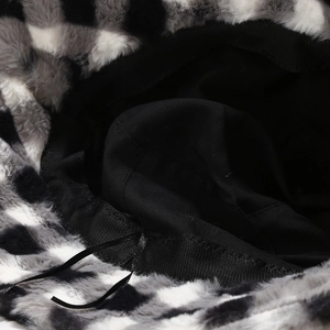 Detail of checkered plush bucket hat showing inner lining and adjustable drawstring