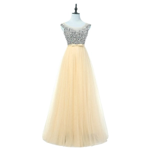 Detail of silver sequins on sleeveless bodice and champagne layered mesh evening gown