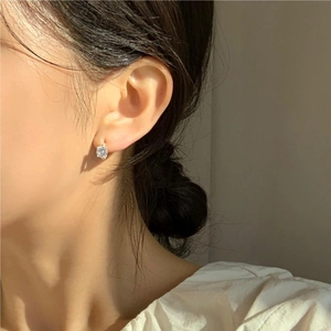 Elegant 925 sterling silver four-prong stud earrings with sparkling clear cubic zirconia