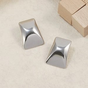 Macro view of minimalist silver square curved earrings with polished mirror finish