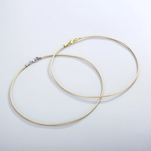 Detail of beige braided wax cord necklaces with gold and silver lobster clasps