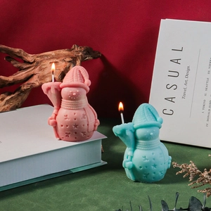Christmas snowman scented candles in pink and blue with holiday relief decorations