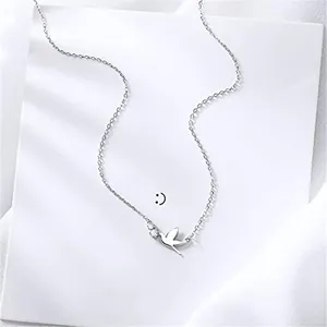 Macro shot of silver swallow pendant necklace with sparkling zircon stone accents