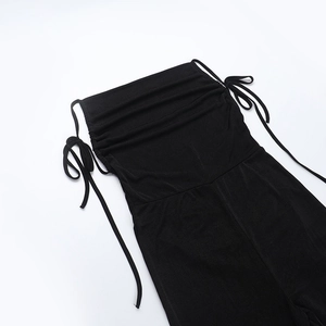 Detail view of the side drawstring and ruched texture on this black knit bodysuit