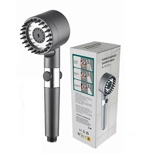 Grey turbocharged shower head with massage brush and one-key stop button near packaging