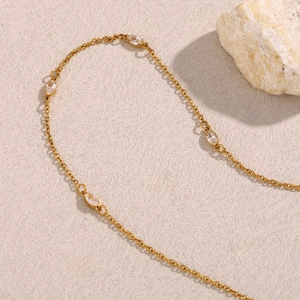 Detailed view of an 18K gold plated stainless steel necklace with marquise zircon stones