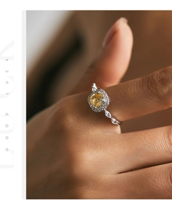 Macro view of S925 silver ring featuring a yellow square-cut crystal and halo diamonds
