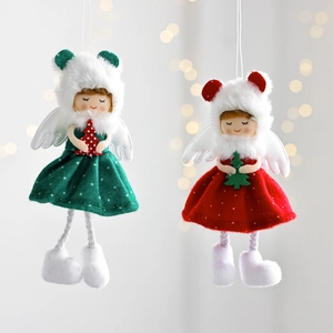Detail of plush Christmas angel dolls with polka dot dresses and mini pine trees