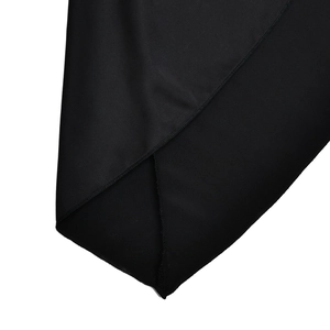 Detailed close-up showing precision stitching and side slit on this black mini dress