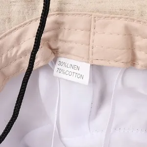 Detailed macro view of linen cotton sun hat fabric and material composition label