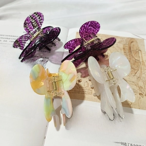 Set of four butterfly hair claws in vintage lace style and diverse marble textures