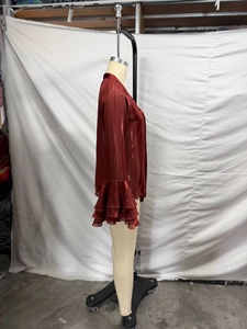 Detail of burgundy flare sleeve blouse with ruffle cuffs and metallic silk stripes