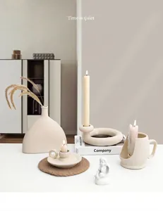 Detail of matte cream ceramic candle holders with textured unglazed finish for home decor