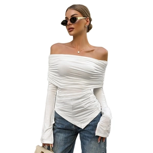 Detailed view of white off-shoulder top with pleated texture and asymmetric hemline
