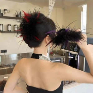 Ostrich feather hair claw clip and long tassel earrings set on a model in a cafe