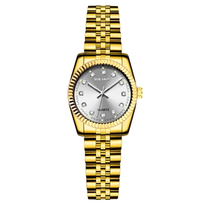 Detail view of gold women's watch featuring a silver dial with diamond indices