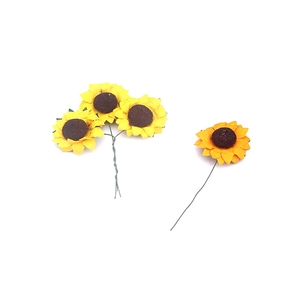 Detail showing four artificial sunflower heads with vibrant yellow petals and brown centers