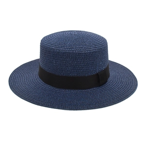 Detail of dark blue boater hat with black grosgrain ribbon and fine straw texture