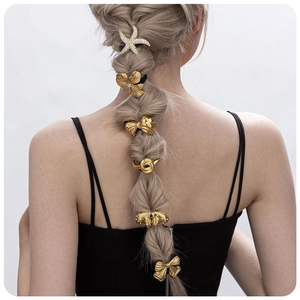 Gold stainless steel hair charms with crystals on a braided ponytail for women