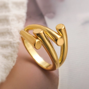 Minimalist gold geometric ring with polished interlaced cylinders and high-gloss finish