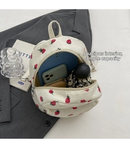 Corduroy backpack interior detail showing storage space for phone, wallet and umbrella