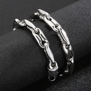 Detailed close-up of chunky silver coffee bean chain link necklaces with lobster clasps