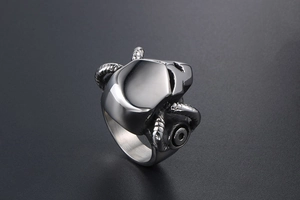 Detailed close-up of gothic stainless steel ring with skull and mechanical ram horns