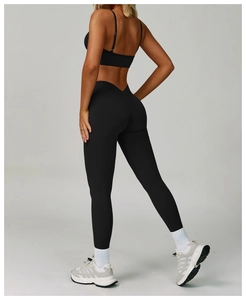 Macro shot of high-waist black yoga leggings with V-shaped waistband for tummy control