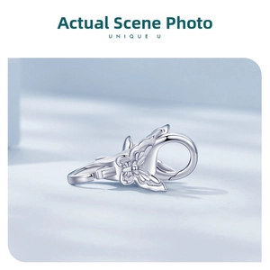 Macro shot of a 925 sterling silver lobster clasp featuring an etched butterfly motif