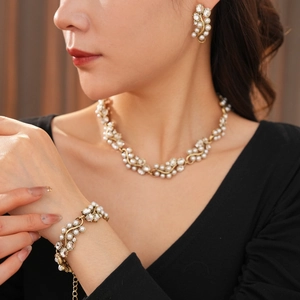 Elegant vintage jewelry set with oval pearls and crystals on gold metal vine design