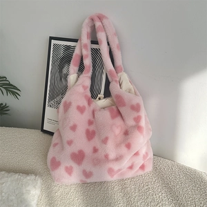 Detail of pink faux fur heart tote bag showing plush texture and metal magnetic closure