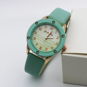 Detail of mint green leather strap and wavy gradient dial with rose gold numbers