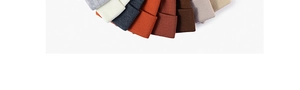 Flat lay showing various colors of thick double-layer knit beanies in ribbed texture