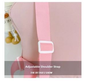 Detailed view of the adjustable pink shoulder strap with white plastic buckle on the backpack