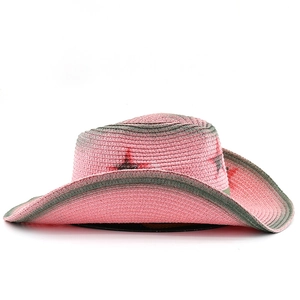 Detailed side view of pink Y2K straw cowboy hat with gray star patterns and wide brim