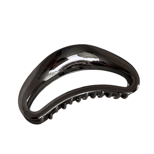 Polished black crescent shark hair claw clip with minimalist cutout design for women