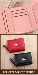 Detail of tri-fold women wallet featuring V-quilted faux leather and bee metal ornament