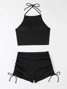 Two-piece black ribbed bikini set featuring a halter top and side-tie high-waisted shorts