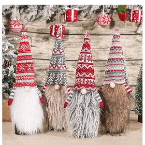 Close-up of knitted Christmas gnome wine bottle covers with striped hats and plush beards