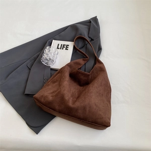 Macro view of brown suede tote bag texture with minimalist vintage aesthetic details
