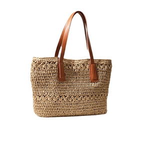 Beige woven straw shoulder bag with brown PU leather straps for summer beach vacations
