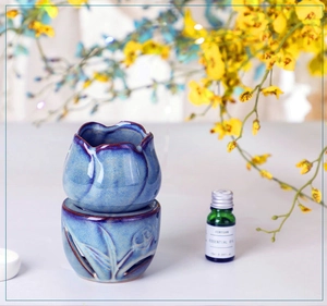 Detail of blue tulip ceramic essential oil burner with hollow base and glossy glaze