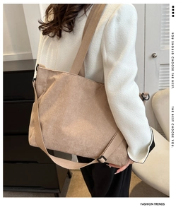 Detail of khaki corduroy tote bag showing rich ribbed texture and metal buckle strap