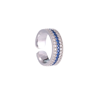 Macro detail of silver adjustable ring with blue and white pavé-set zircon compass design