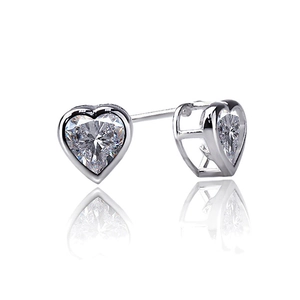 Macro detail of heart-cut cubic zirconia studs with polished silver-tone prongs