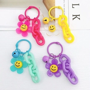 Colorful smiley flower keychain pendants with matching chains and bells for DIY crafts