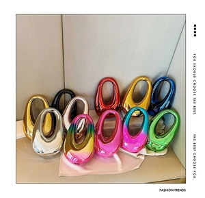 Close-up of metallic electroplated hollowing-out handbags in various vibrant colors