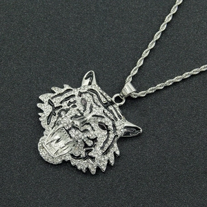 Close-up of silver tiger head pendant with inlaid rhinestones and black gem eyes